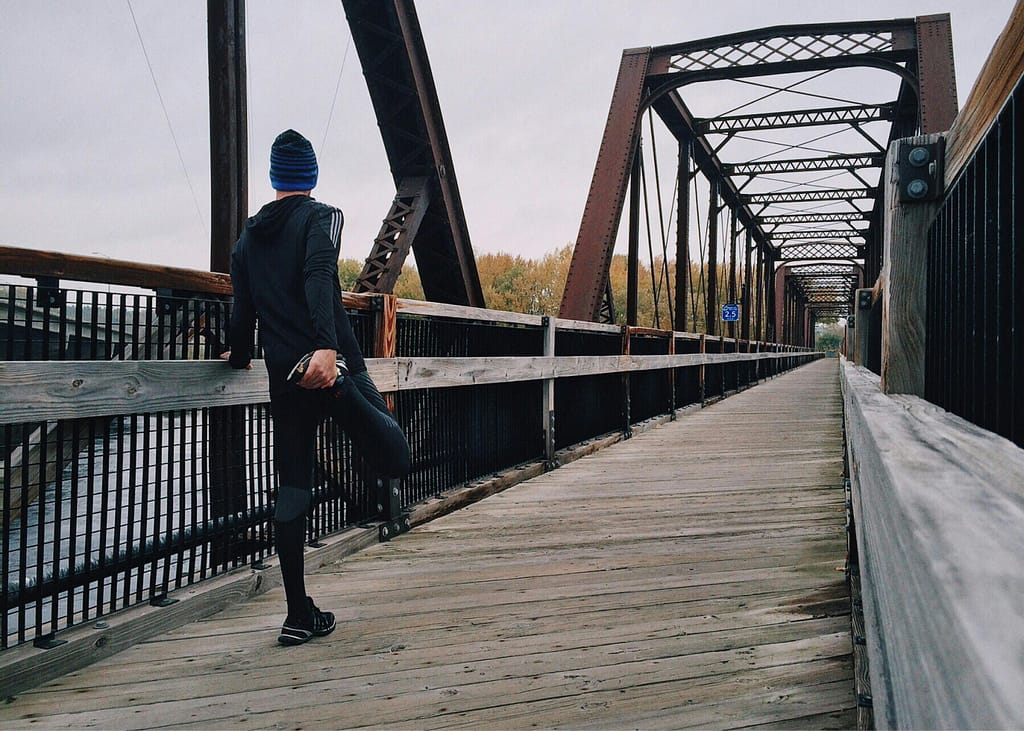 Man on bridge proper running form for distance