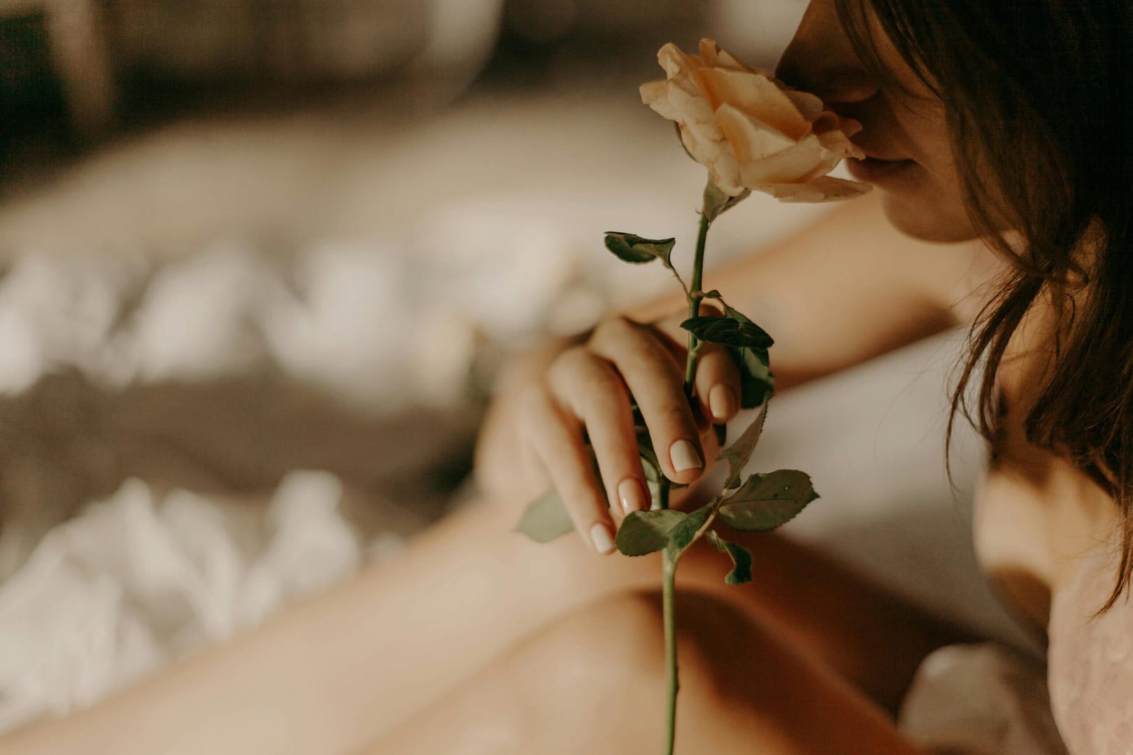 woman smelling rose best floral perfume for women