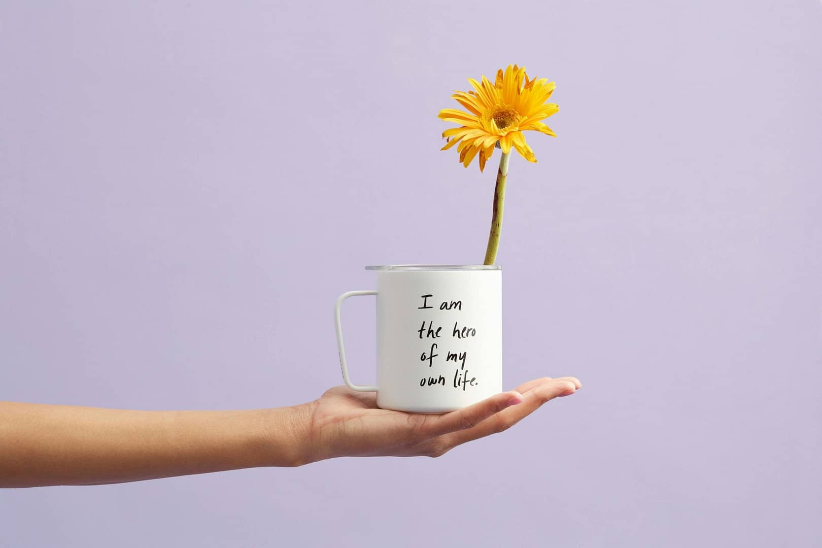 woman holding cup with flower self care affirmations